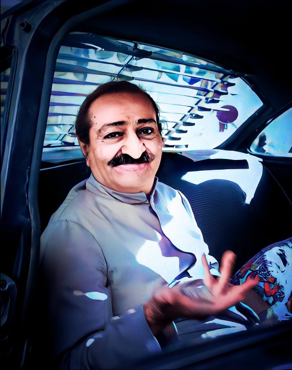 Meher Baba seated in car gesturing